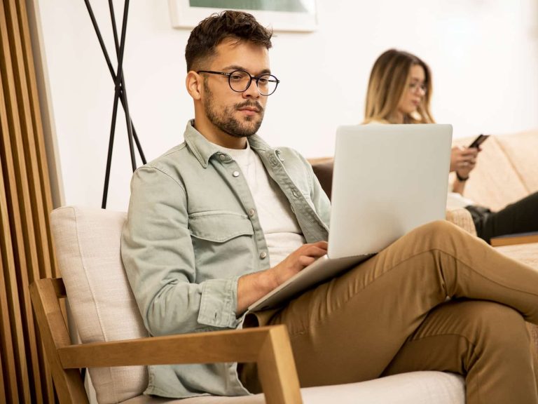 young-man-using-laptop-at-home-2022-04-21-19-31-41-utc (1)